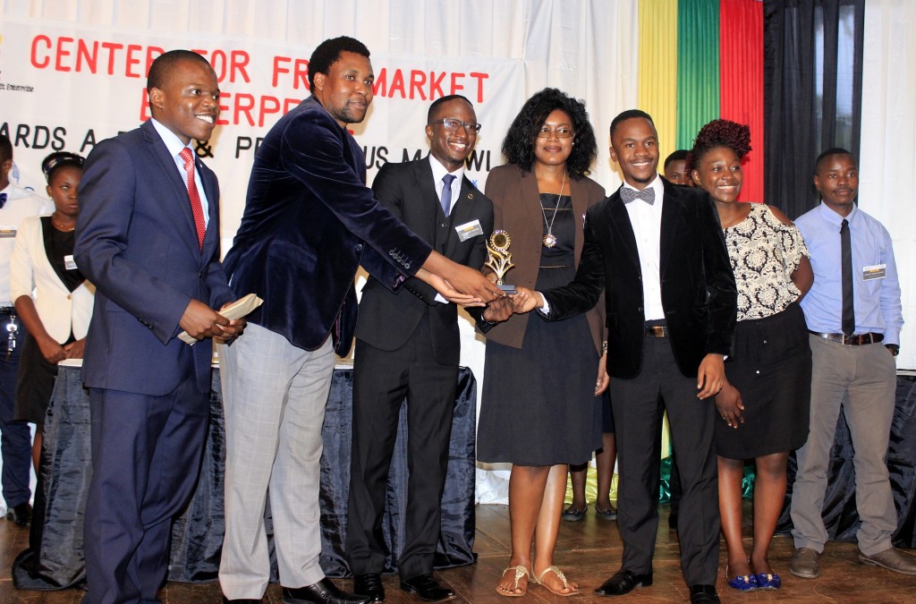 Peter Yakobe awarding winners of 2016 inter-varsity debate