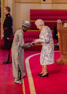 Imrana receiving his award from the Queen of England